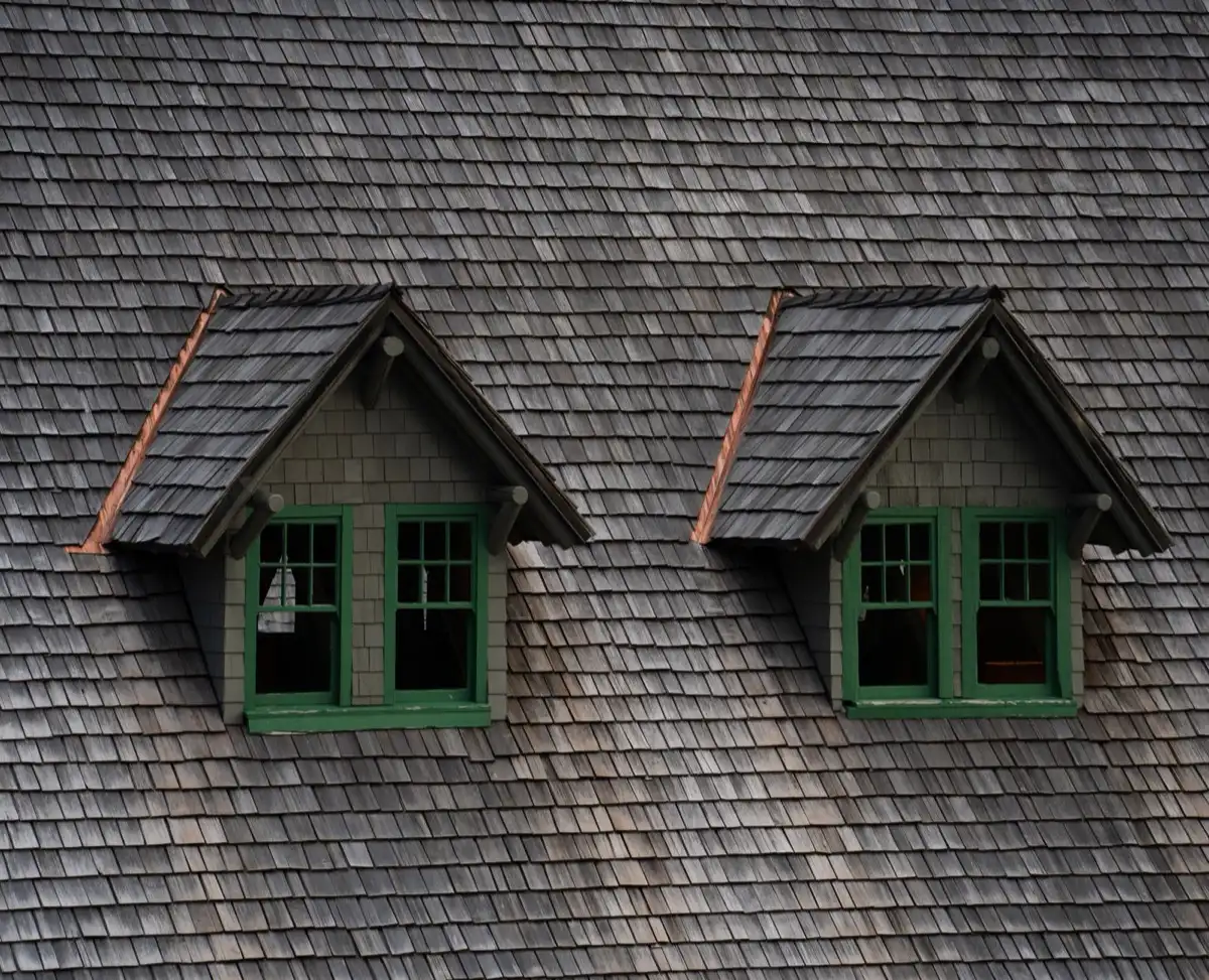 Dormers on a shingle roof in Stephenville, TX, where step flashing and kickout flashing carry water past the walls